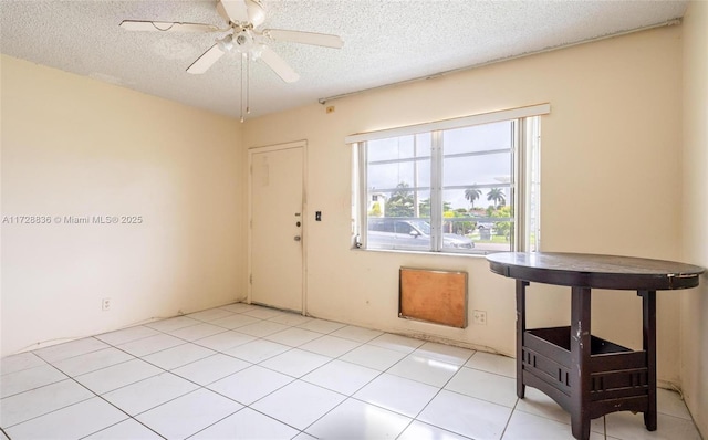 spare room featuring a textured ceiling and ceiling fan