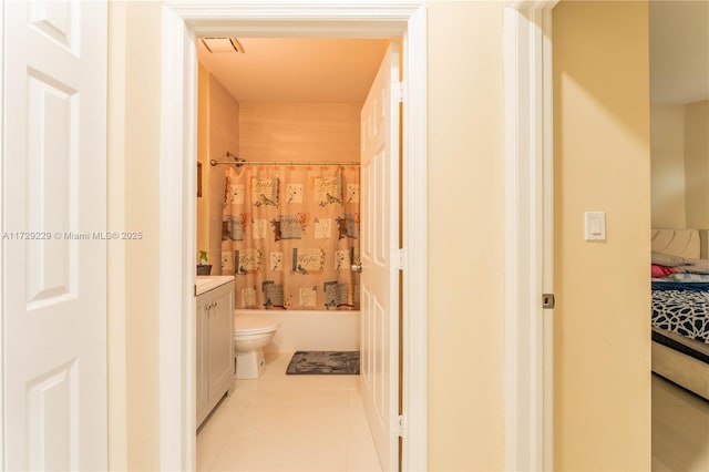 full bathroom with toilet, vanity, shower / tub combo with curtain, and tile patterned floors