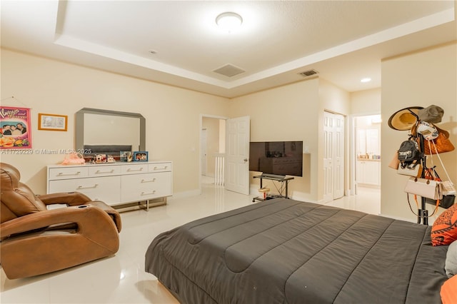 bedroom with a raised ceiling and a closet