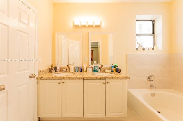 bathroom with vanity and a tub