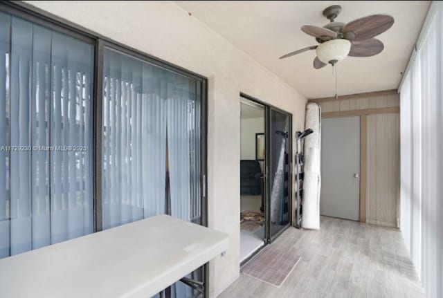 sunroom featuring ceiling fan