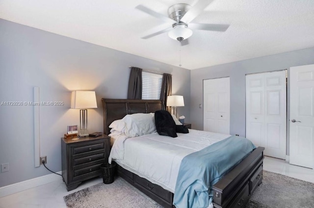 bedroom with multiple closets and ceiling fan