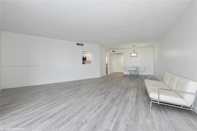 unfurnished living room with light hardwood / wood-style flooring