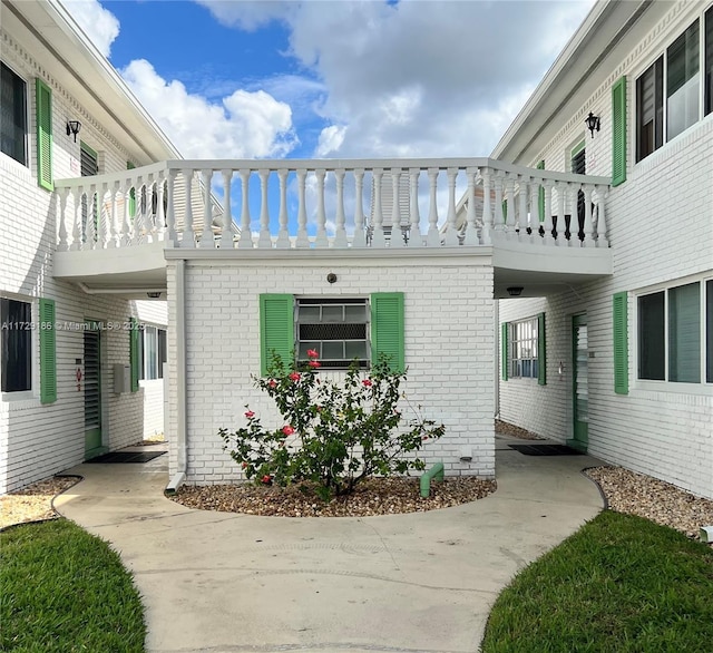 view of side of property with a balcony