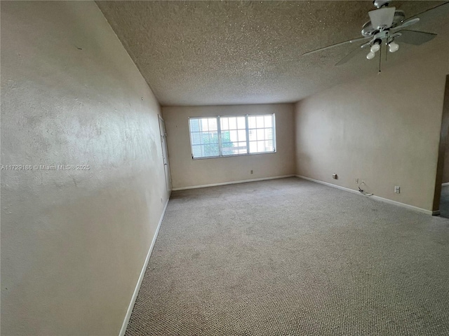 empty room with a textured ceiling, ceiling fan, and light colored carpet