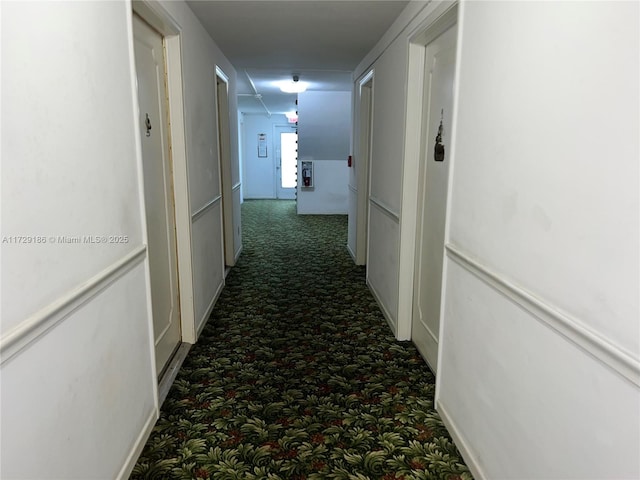 corridor featuring dark carpet