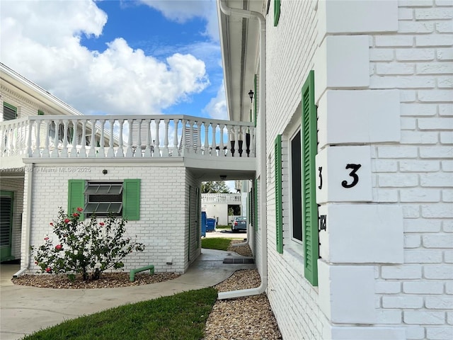 view of side of property with a balcony