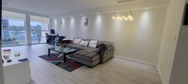 living room featuring light hardwood / wood-style flooring and a notable chandelier