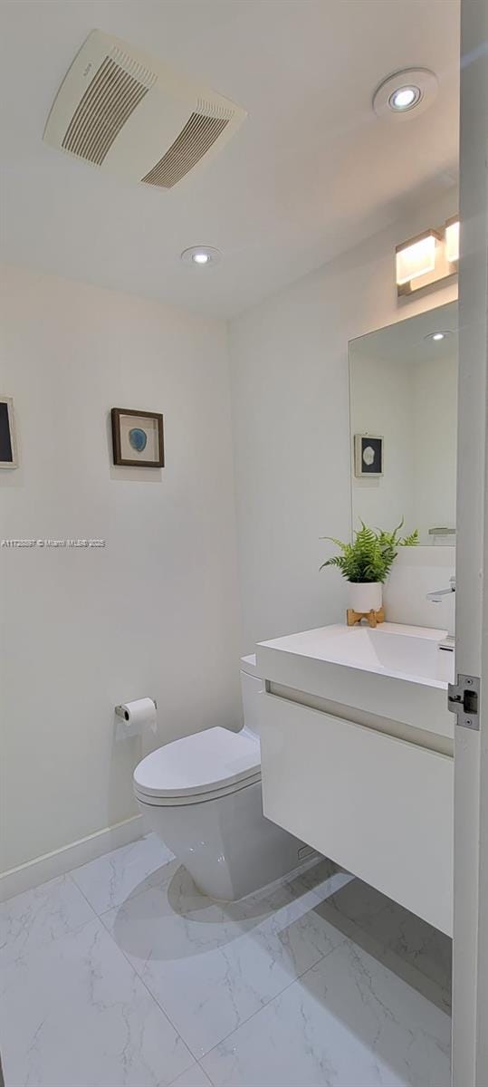 bathroom featuring toilet and vanity