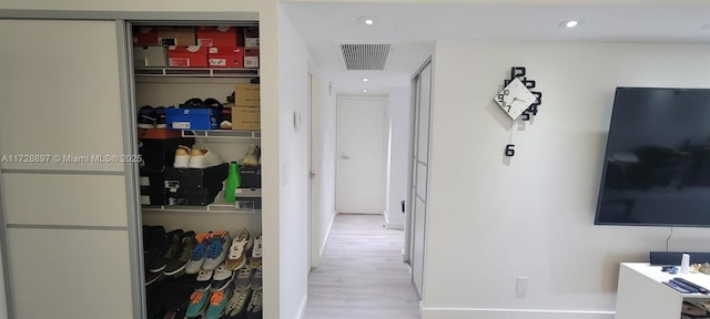 hallway with light hardwood / wood-style flooring