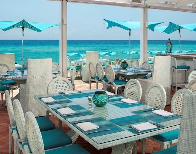 dining area with parquet flooring, plenty of natural light, and a water view