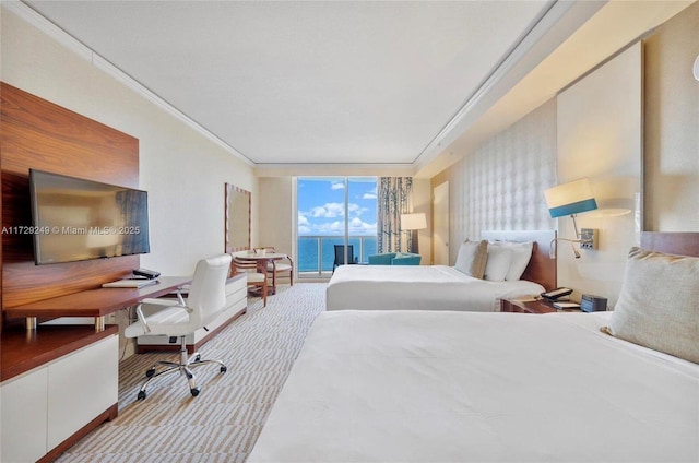 bedroom with light colored carpet, access to outside, crown molding, expansive windows, and a water view