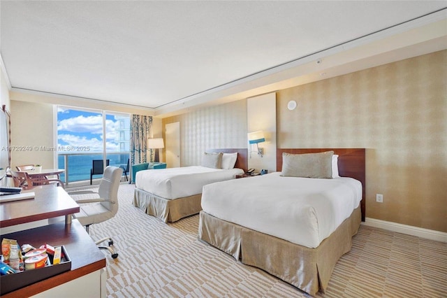 carpeted bedroom featuring floor to ceiling windows and a water view