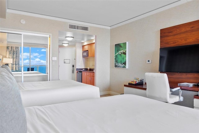 bedroom with ornamental molding, a water view, and sink