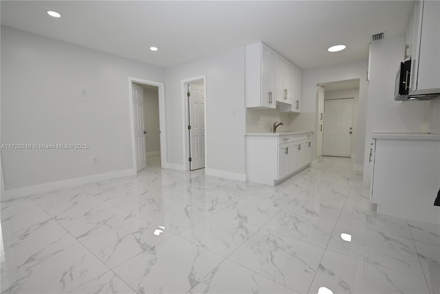 kitchen with sink and white cabinets