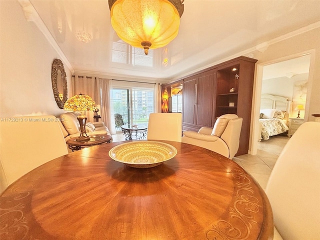 dining space with light tile patterned floors and ornamental molding