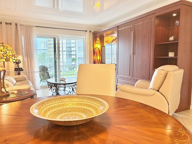 sitting room featuring light tile patterned flooring and ornamental molding