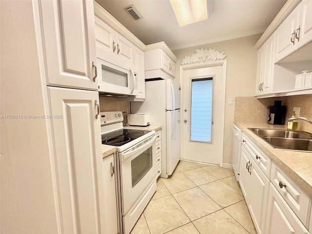 kitchen with backsplash, sink, white appliances, white cabinetry, and light tile patterned floors