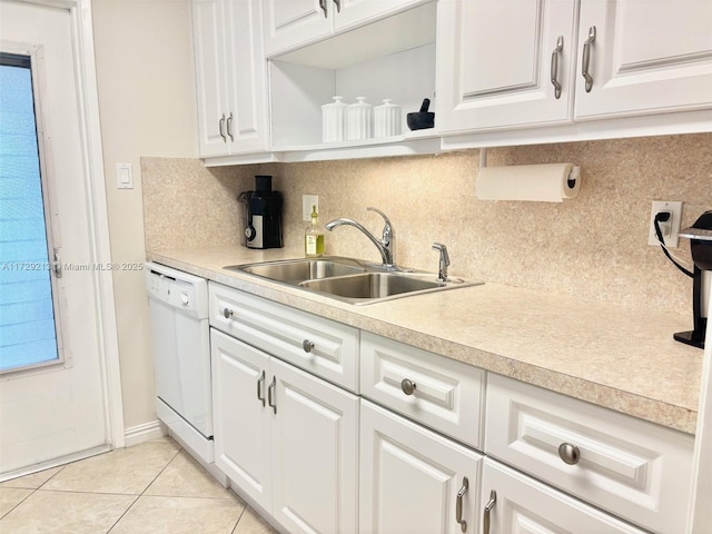 kitchen featuring white cabinetry, light tile patterned floors, tasteful backsplash, dishwasher, and sink