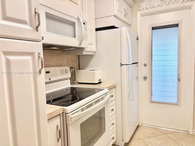 kitchen with backsplash, light tile patterned flooring, white appliances, and white cabinetry