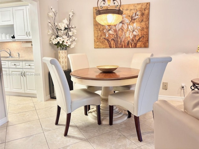 dining space with sink and light tile patterned flooring