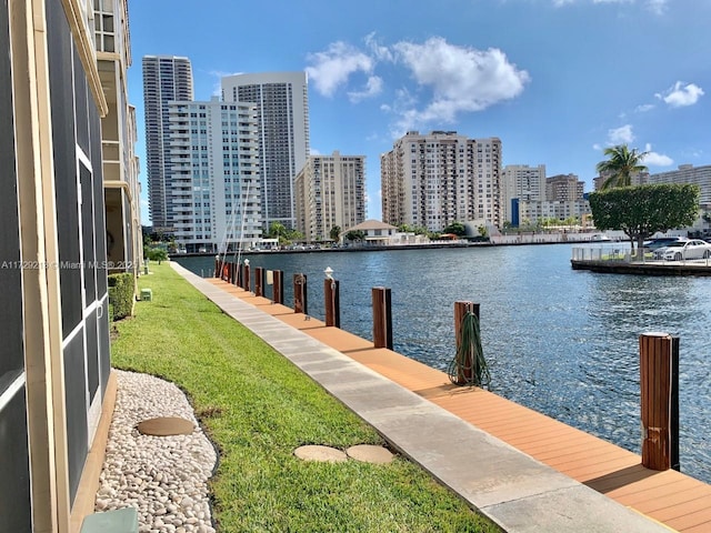 view of dock featuring a yard and a water view