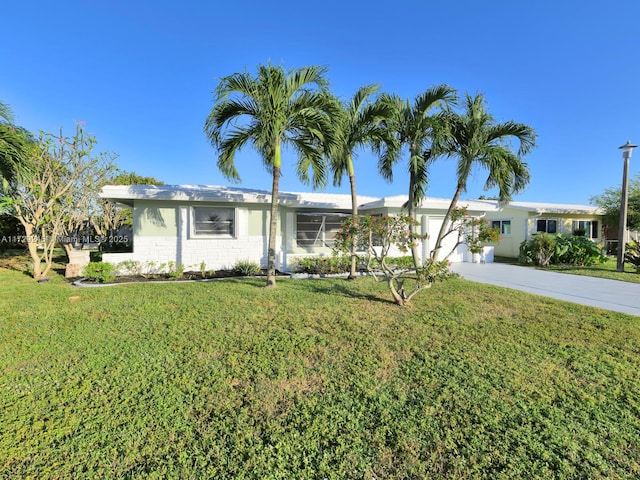 ranch-style home with a front yard and a garage