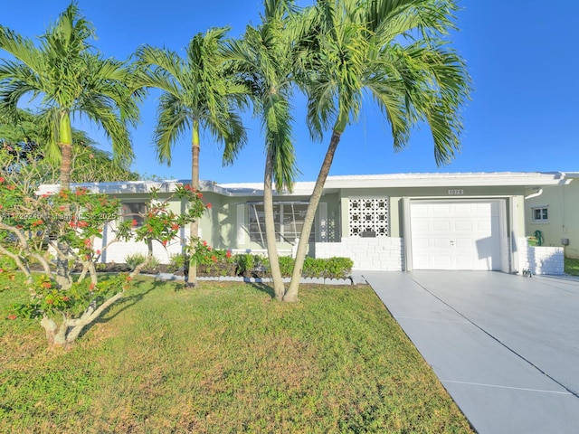 single story home featuring a garage and a front lawn