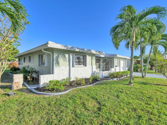 ranch-style home with a front yard and a garage