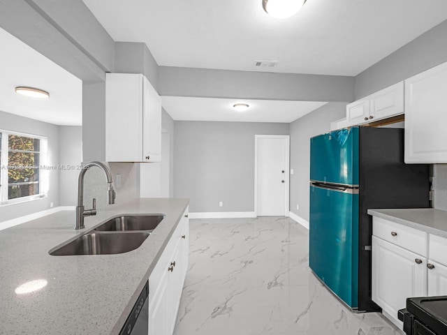 kitchen featuring light stone countertops, dishwasher, white cabinetry, sink, and fridge