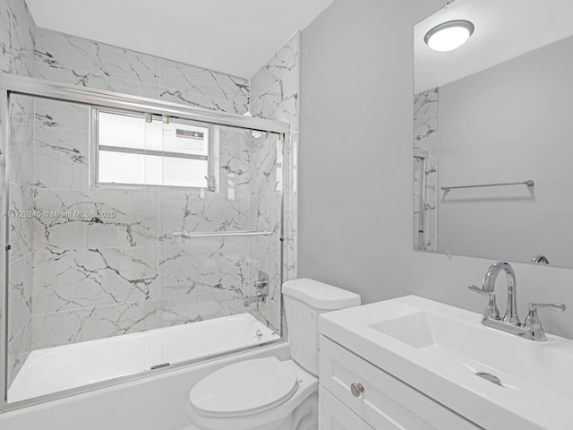 full bathroom featuring toilet, bath / shower combo with glass door, and vanity