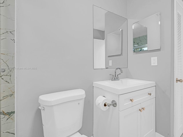 bathroom with toilet and vanity