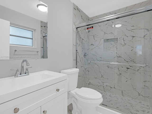 bathroom featuring toilet, vanity, and an enclosed shower