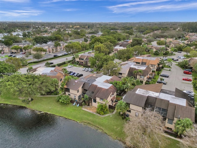 drone / aerial view with a residential view and a water view