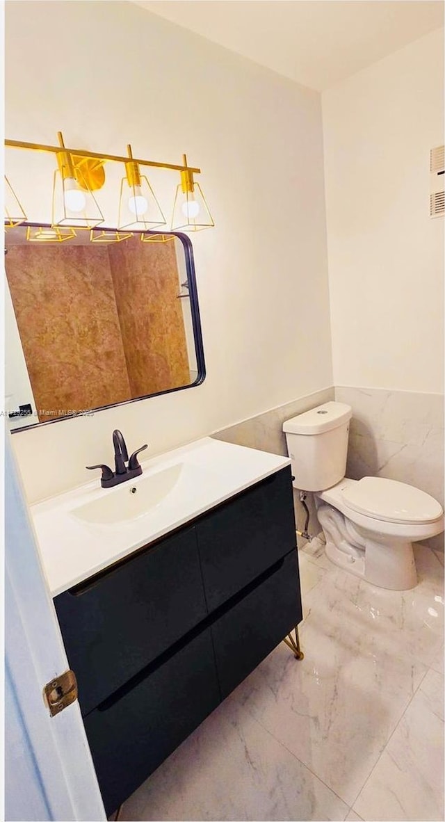 bathroom with vanity and toilet