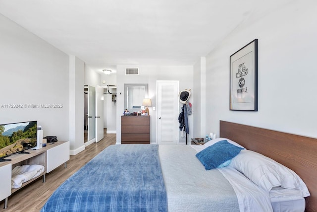 bedroom with hardwood / wood-style flooring