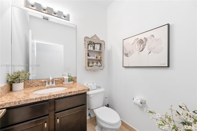 bathroom with toilet and vanity