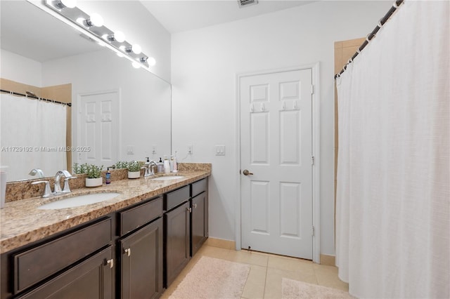 bathroom featuring tile patterned flooring and vanity