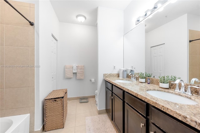 full bathroom featuring toilet, vanity, tiled shower / bath combo, and tile patterned floors