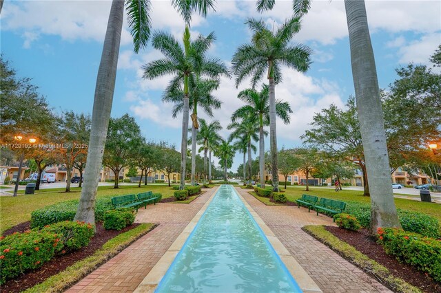 view of pool featuring a lawn