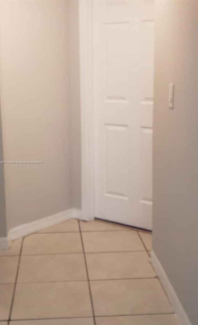 corridor featuring light tile patterned flooring