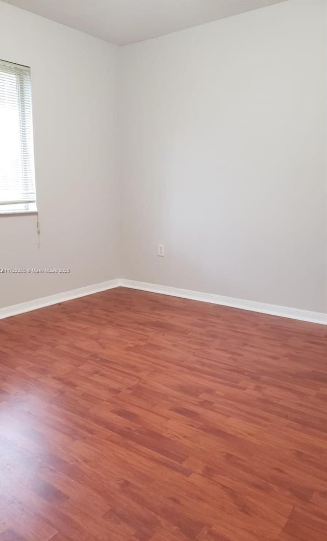 spare room featuring wood-type flooring