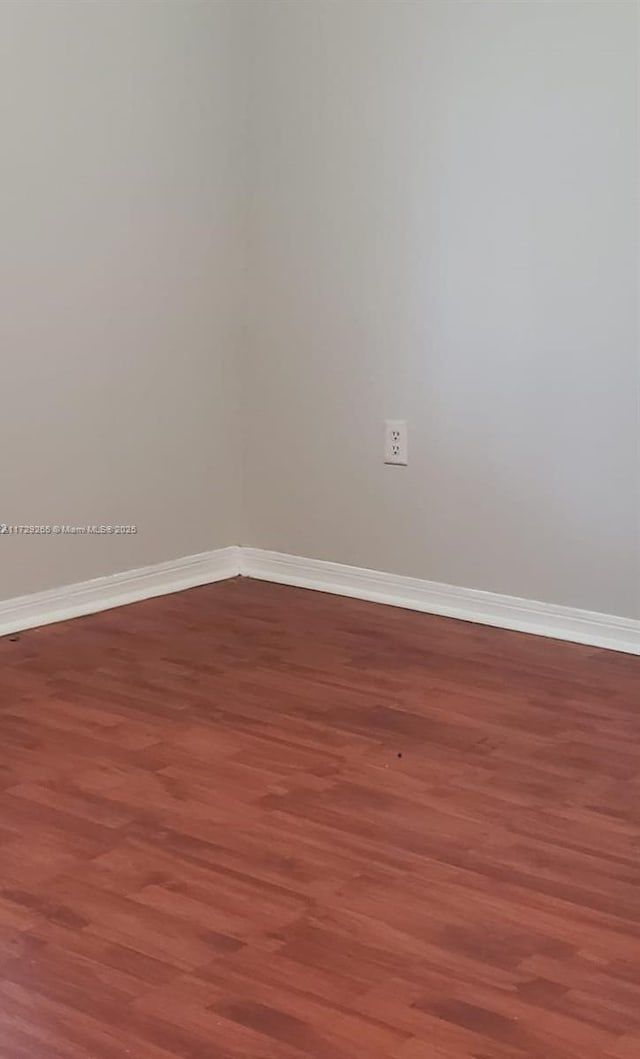 unfurnished room with hardwood / wood-style floors