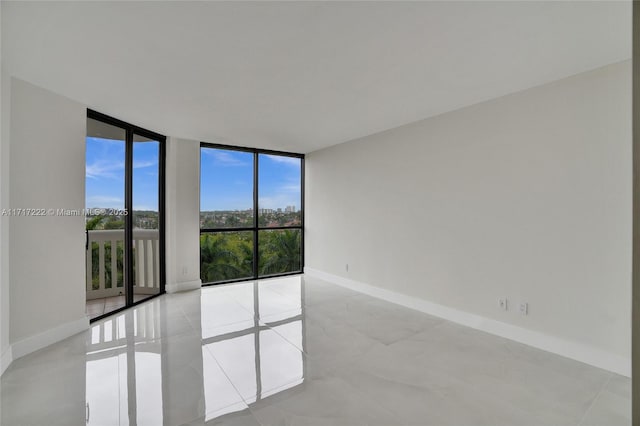 spare room featuring a wall of windows