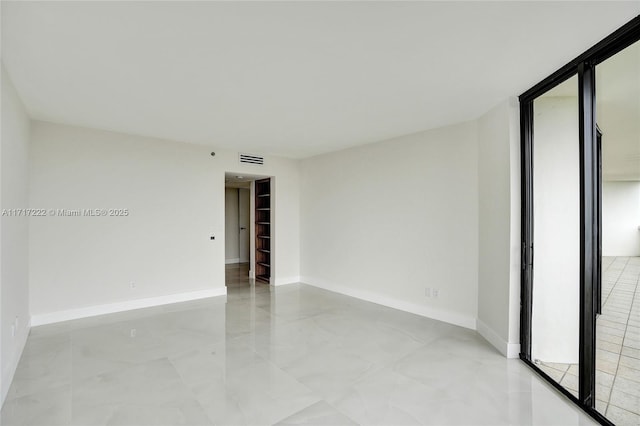 unfurnished room featuring floor to ceiling windows