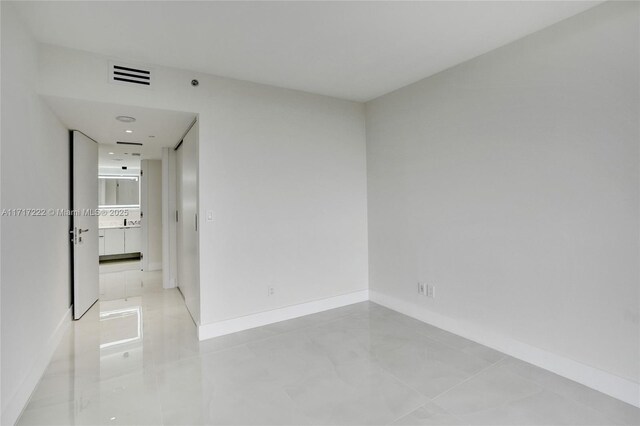 empty room with light tile patterned floors