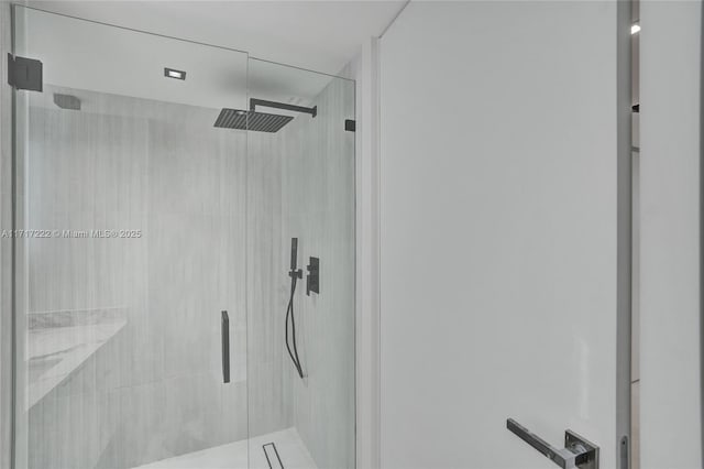 bathroom with a shower with door