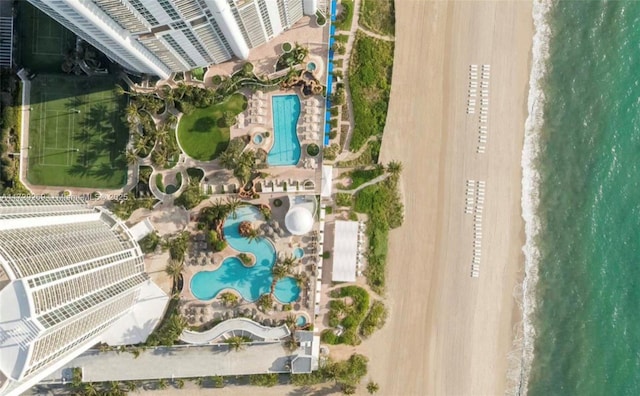 birds eye view of property with a beach view and a water view