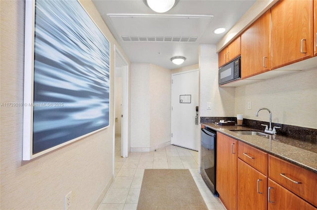 kitchen featuring light tile patterned floors, sink, dark stone counters, and black appliances