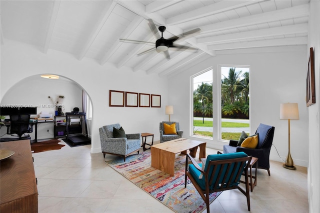 tiled living room with ceiling fan and lofted ceiling with beams